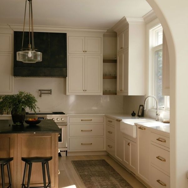 Modern White Inset Kitchen Cabinets with Brass Hardware Modern kitchen with white inset cabinets, flush doors, and brass hardware in a bright residential space