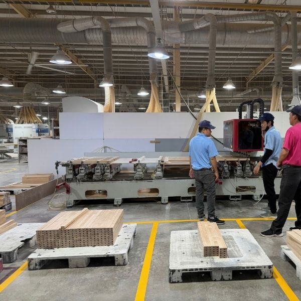 CNC machine producing RTA kitchen cabinet components in factory