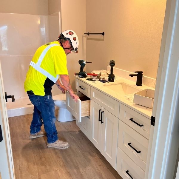 workers assembling RTA cabinets on construction site