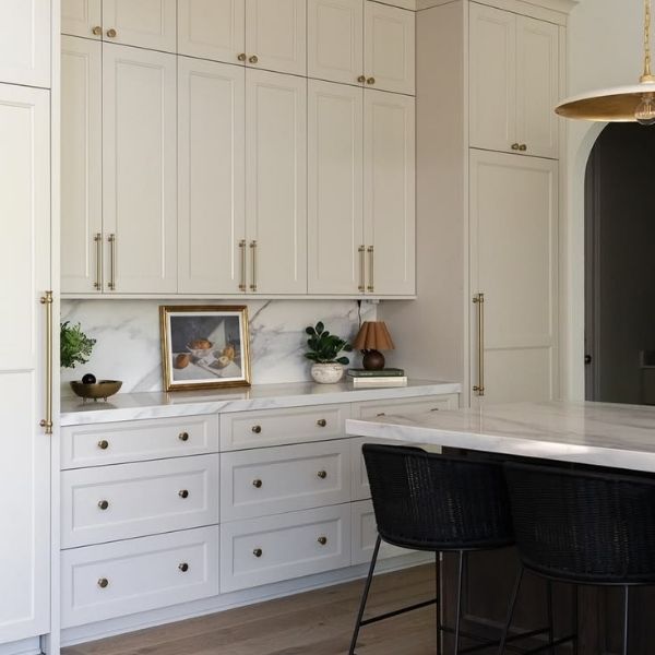 Modern kitchen featuring white shaker cabinets and quartz countertops