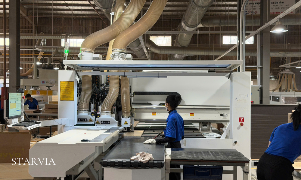 CNC production line manufacturing white shaker kitchen cabinets in Vietnam.