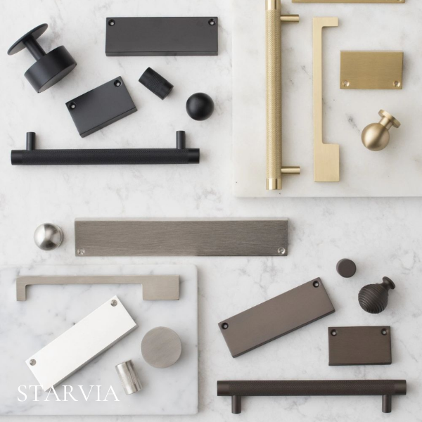 Cabinet hardware finish samples including matte black, brushed brass, satin nickel and graphite